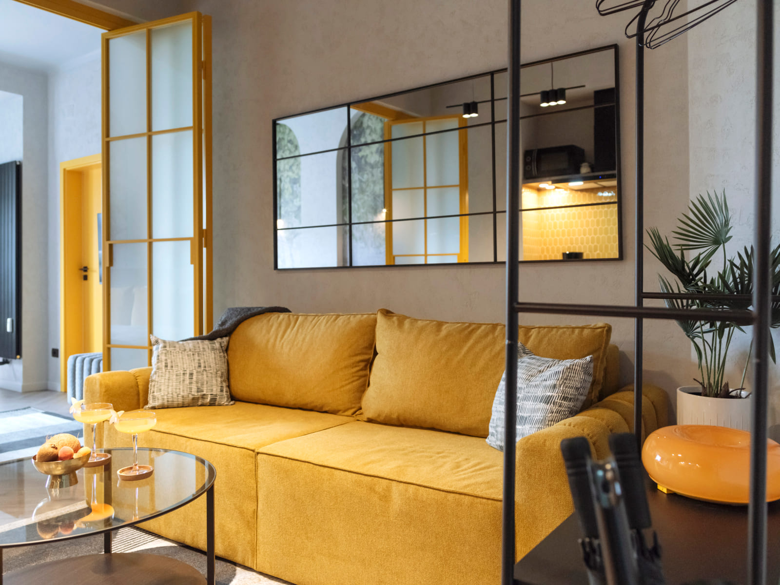 Demeter Studio 87 — Yellow sofa and the mirror wall