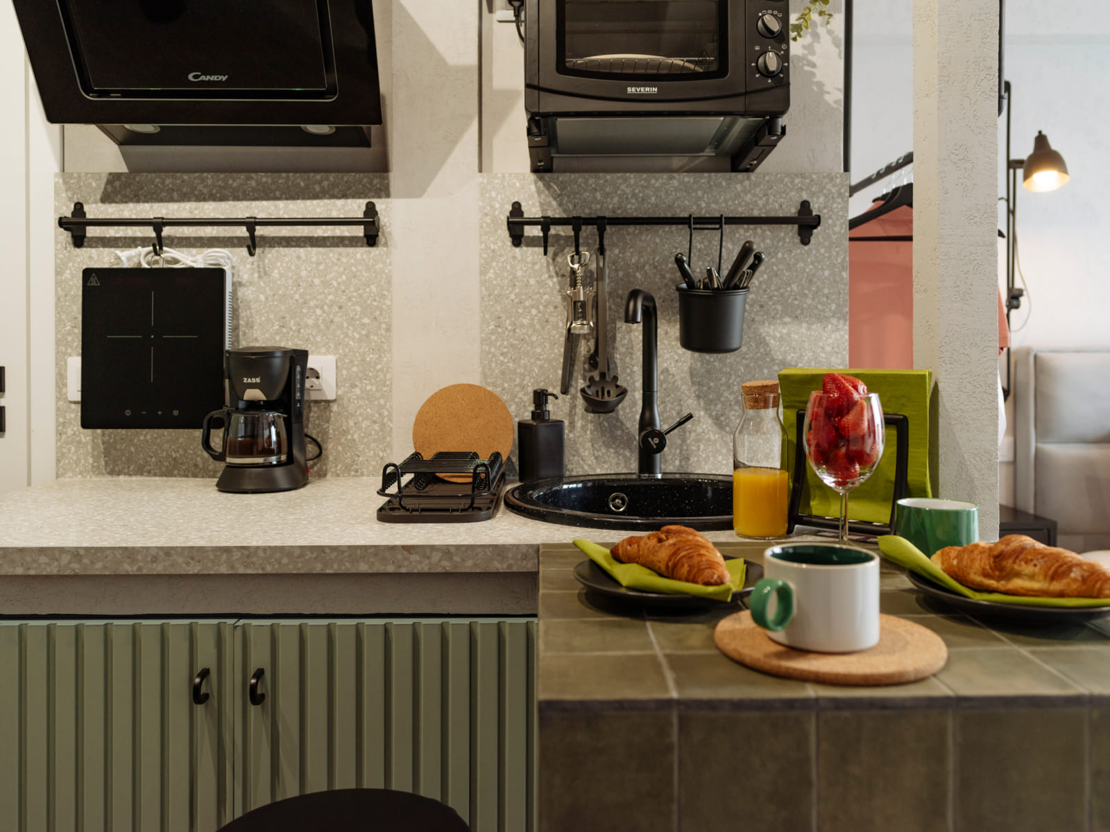 Zalomit Studio 81 — Green cabinets and terrazzo counter