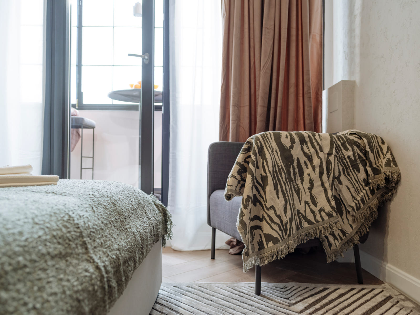 Zalomit Studio 81 — Bed and armchair by the window